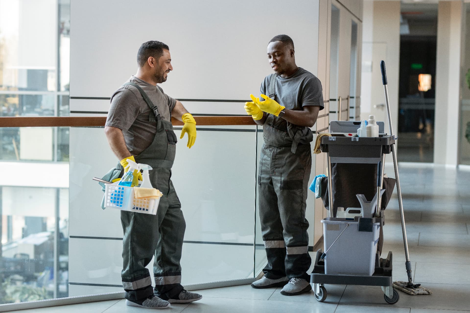 EBC cleaning team with a professional cleaning trolley in a modern office hallway